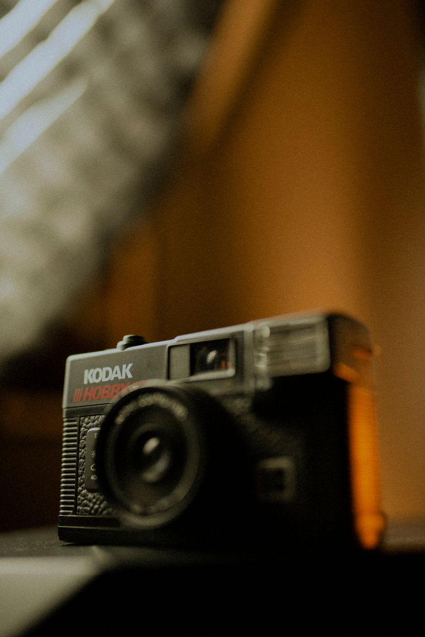 Close-up of a vintage Kodak camera with soft lighting, highlighting its classic design.