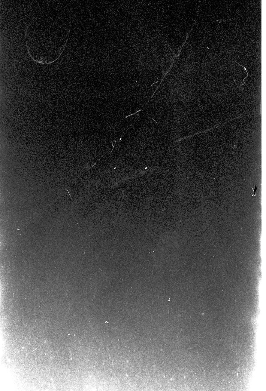 Grainy black and white abstract texture with scratches, ideal for artistic backgrounds.
